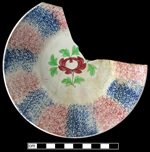 Refined white earthenware saucer with sponged and painted decoration - click to see larger image.